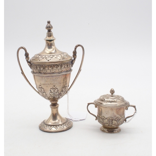 408 - A silver miniature trophy cup and cover, the body with repousse acanthus leaf decoration, with a kno... 