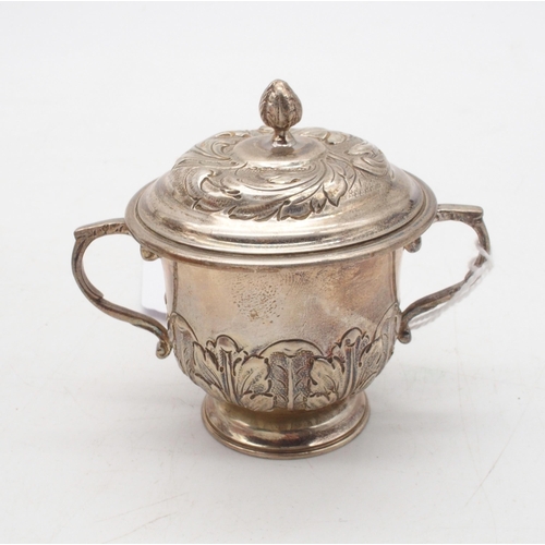 408 - A silver miniature trophy cup and cover, the body with repousse acanthus leaf decoration, with a kno... 