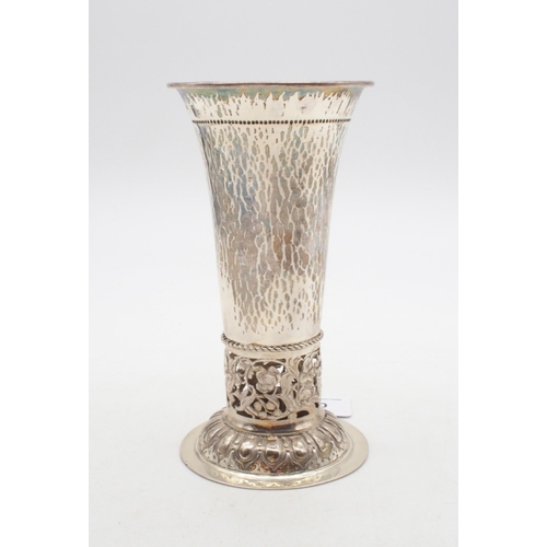 A German silver trumpet vase, the body hammered, with a band of scrolling openwork, the circular base decorated with an egg and dart band, with import marks for Berthold Muller, London 1912, 17cm, 242gms