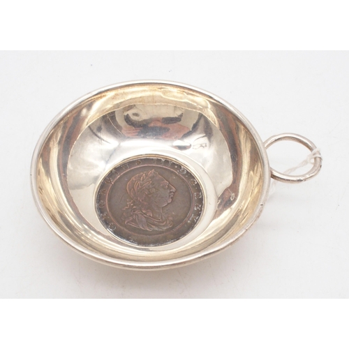 420 - An Elizabeth II silver wine taster, with a George III cartwheel two pence soldered to the base, with... 