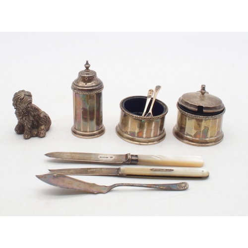 422 - A collection of silver including a three piece cruet set, of faceted form, by J W Benson Ltd, London... 