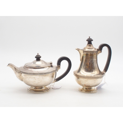 425 - A silver tea and coffee pot, of baluster form, with bands of vine decoration, by Elkington & Co,... 