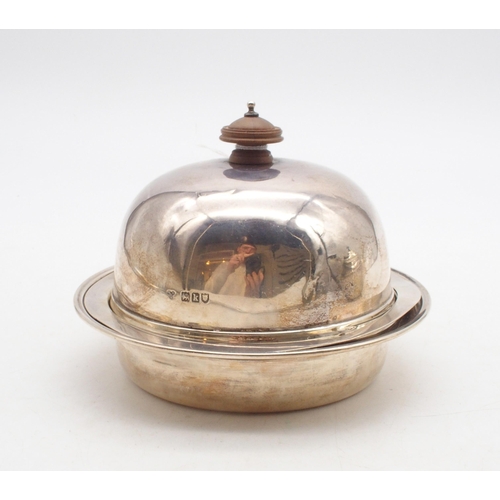 427 - A silver butter dish and cover, the domed lid with a turned wooden finial, open to reveal a silver l... 