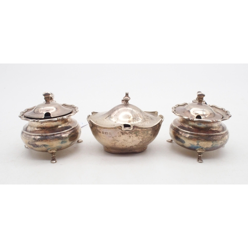 429 - A pair of heavy gauge silver mustard pots, of cauldron form, with a slightly domed lid and a lobed r... 