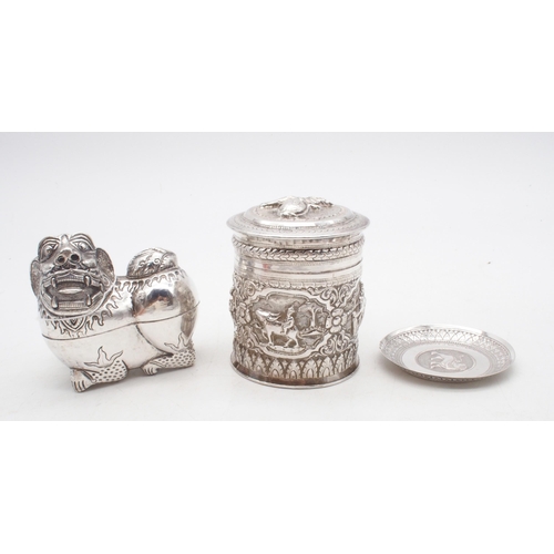 437 - A Cambodian silver betel nut box, modelled as a temple lion, an Indian white metal cylindrical box, ... 