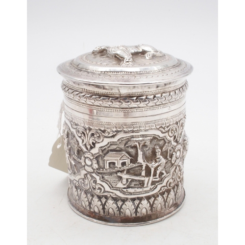 437 - A Cambodian silver betel nut box, modelled as a temple lion, an Indian white metal cylindrical box, ... 