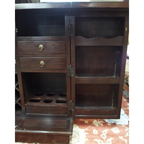 51 - A 20th century Oriental hardwood drinks cabinet with pair of fold out top concealing marble insert o... 