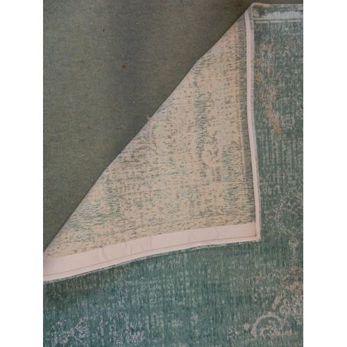 69 - A modern aqua ground Belgian Louis de Poortere rug with distressed Kashan design, 240cm long x 170cm... 