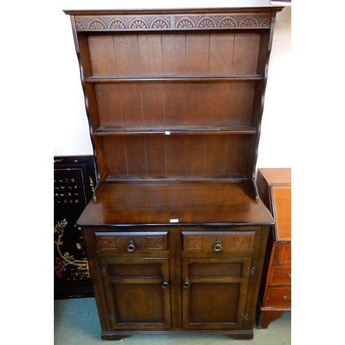 71 - A 20th century mahogany kitchen dresser with plate rack over two drawers over pair of cabinet doors,... 