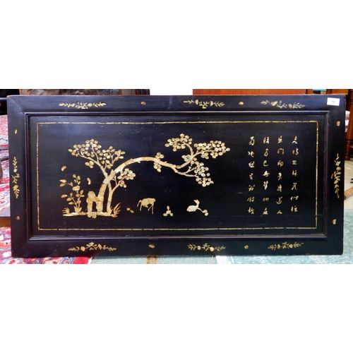 72 - An early 20th century Oriental lacquered panel with mother of pearl inlays, 51cm high x 106cm wide