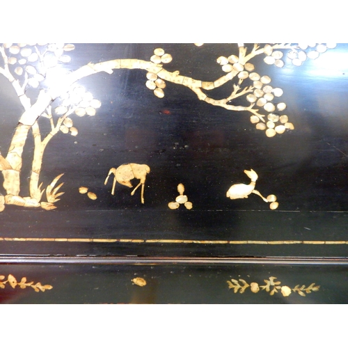 72 - An early 20th century Oriental lacquered panel with mother of pearl inlays, 51cm high x 106cm wide