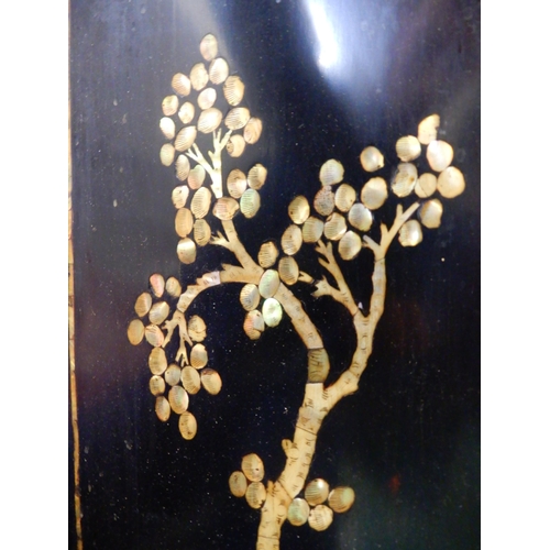 72 - An early 20th century Oriental lacquered panel with mother of pearl inlays, 51cm high x 106cm wide