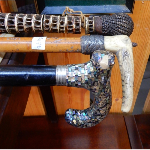 77 - A gents walking stick constructed of vertebrae, another walking stick, riding crop, framed tapestry ... 