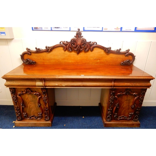 84 - A Victorian mahogany pedestal sideboard with carved scrolled back splash over long drawer flanked by... 