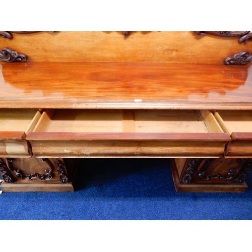 84 - A Victorian mahogany pedestal sideboard with carved scrolled back splash over long drawer flanked by... 