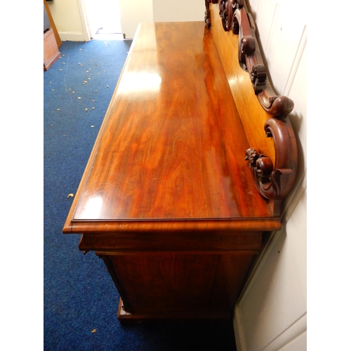 84 - A Victorian mahogany pedestal sideboard with carved scrolled back splash over long drawer flanked by... 