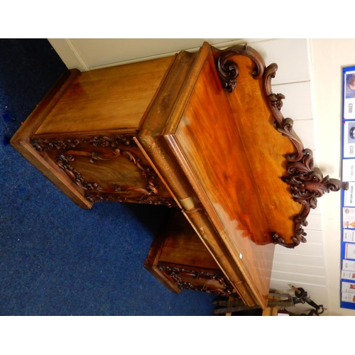 84 - A Victorian mahogany pedestal sideboard with carved scrolled back splash over long drawer flanked by... 