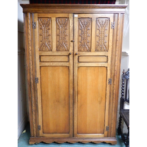 85 - A 20th century oak two door wardrobe, 191cm high x 127cm wide x 59cm deep