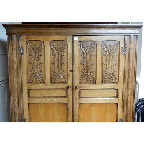 85 - A 20th century oak two door wardrobe, 191cm high x 127cm wide x 59cm deep