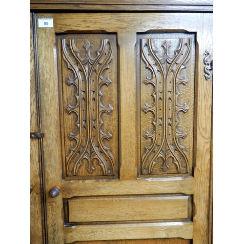 85 - A 20th century oak two door wardrobe, 191cm high x 127cm wide x 59cm deep