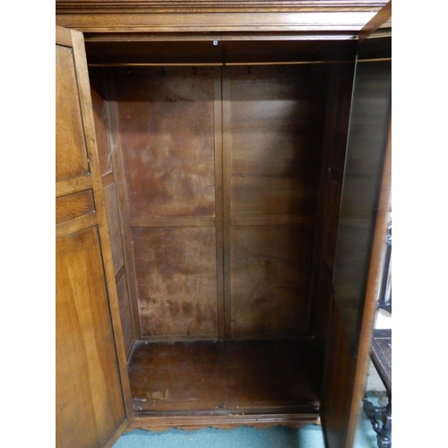 85 - A 20th century oak two door wardrobe, 191cm high x 127cm wide x 59cm deep