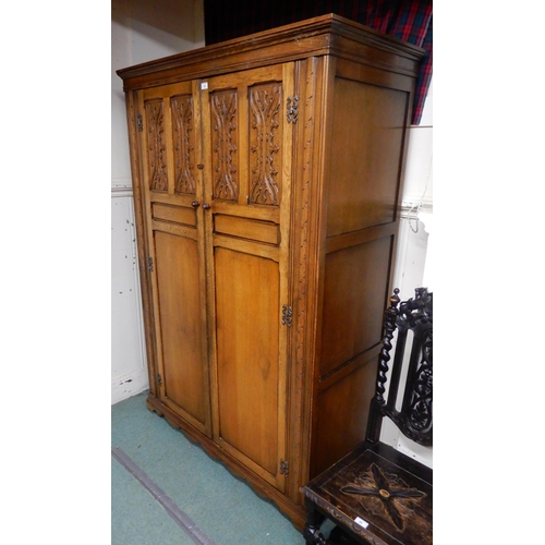 85 - A 20th century oak two door wardrobe, 191cm high x 127cm wide x 59cm deep