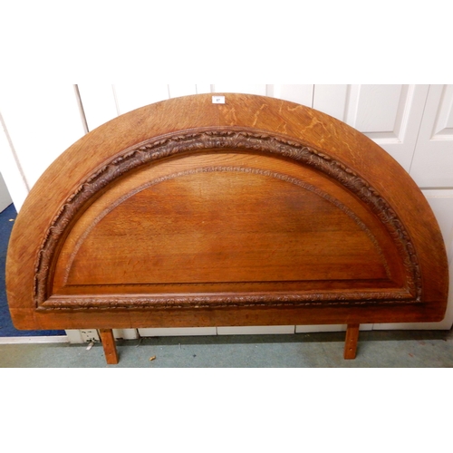 87 - A 20th century oak demi lune head board, 113cm high x 180cm wide and a mahogany nest of three tables... 