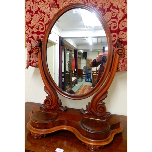 88 - A Victorian mahogany oval dressing mirror and a box of assorted brass and copper wares (2)