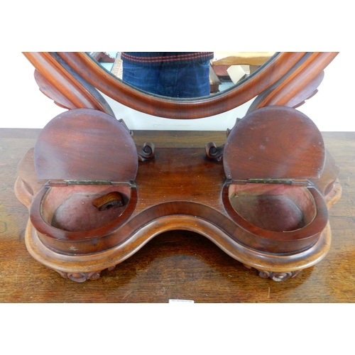 88 - A Victorian mahogany oval dressing mirror and a box of assorted brass and copper wares (2)