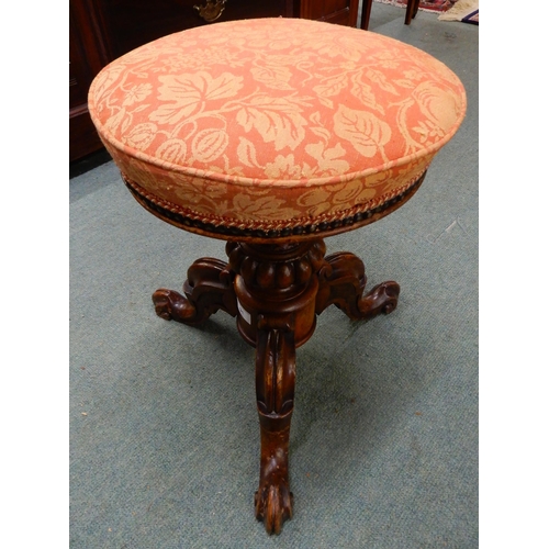 91 - A Victorian walnut adjustable piano stool with fruit and foliate upholstered seat on baluster tripod... 