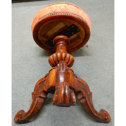 91 - A Victorian walnut adjustable piano stool with fruit and foliate upholstered seat on baluster tripod... 