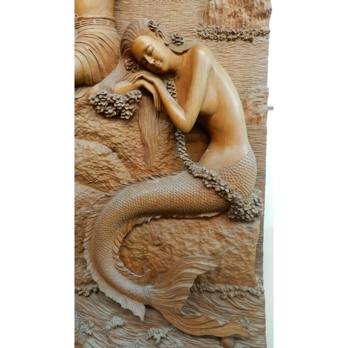 95 - A 20th century hardwood wall sculpture of a piper and a mermaid, 162cm high x 65cm wide