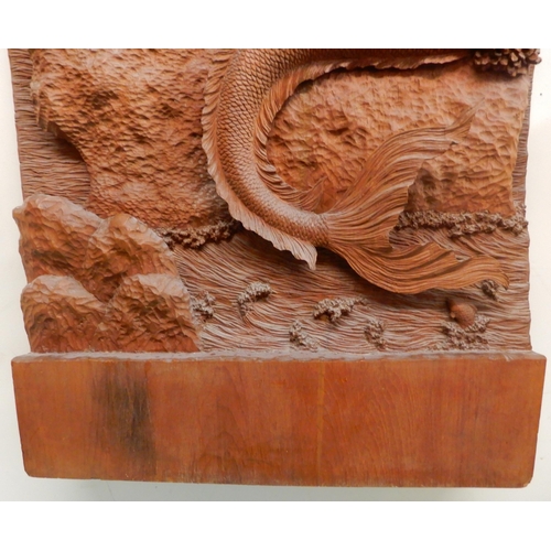 95 - A 20th century hardwood wall sculpture of a piper and a mermaid, 162cm high x 65cm wide