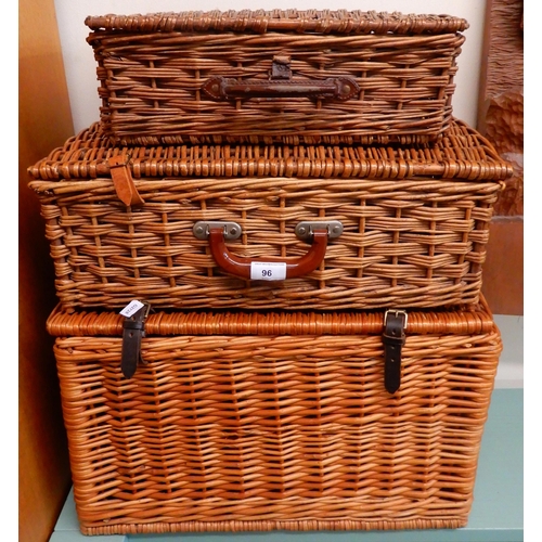 96 - A lot of three assorted wicker picnic hampers and a child's doll house (4)