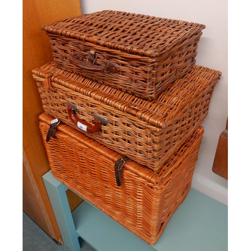 96 - A lot of three assorted wicker picnic hampers and a child's doll house (4)