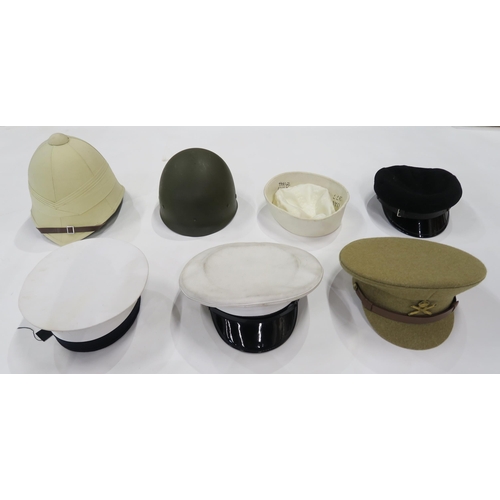 539 - An assortment of mainly reproduction military and other headgear, to include a pith helmet, Machine ... 