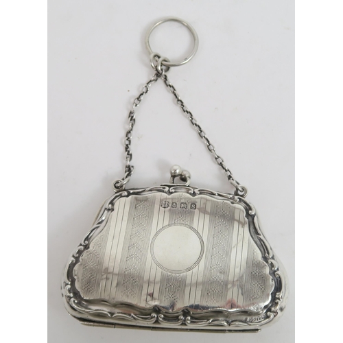 739A - A George V silver purse, the shaped body with a scrolling border, with bands of engine turned decora... 