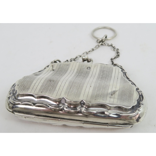 739A - A George V silver purse, the shaped body with a scrolling border, with bands of engine turned decora... 