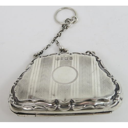 739A - A George V silver purse, the shaped body with a scrolling border, with bands of engine turned decora... 