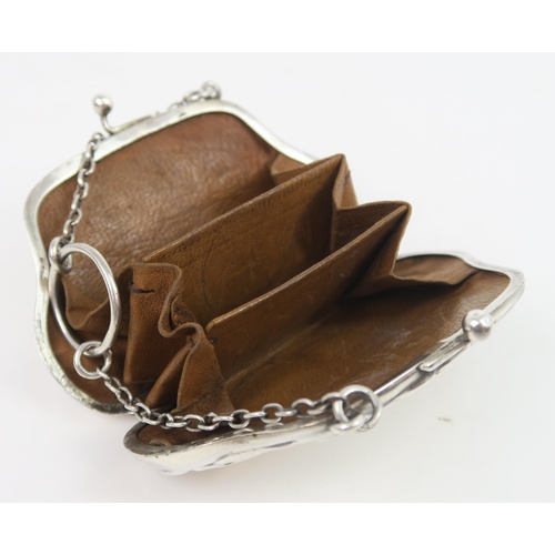 739A - A George V silver purse, the shaped body with a scrolling border, with bands of engine turned decora... 