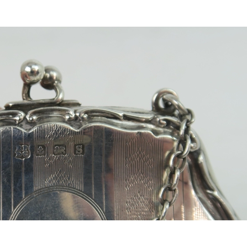 739A - A George V silver purse, the shaped body with a scrolling border, with bands of engine turned decora... 