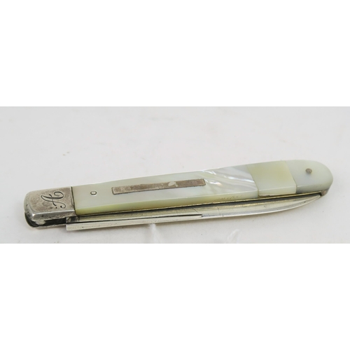 748A - A Victorian silver and mother of pearl fruit knife, the handle with a blank rectangular cartouche, t... 