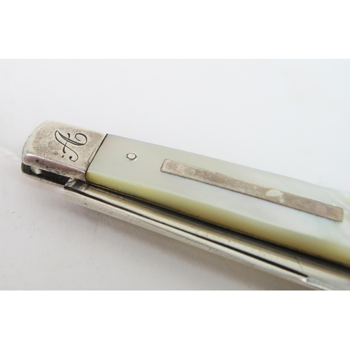 748A - A Victorian silver and mother of pearl fruit knife, the handle with a blank rectangular cartouche, t... 