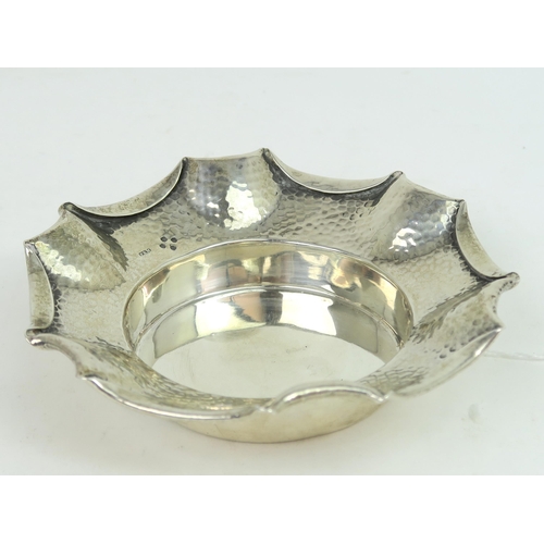 759B - A Victorian silver arts and crafts style dish, the body with a hammered finish, with a fold over pie... 