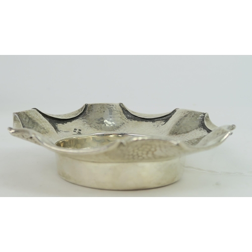 759B - A Victorian silver arts and crafts style dish, the body with a hammered finish, with a fold over pie... 