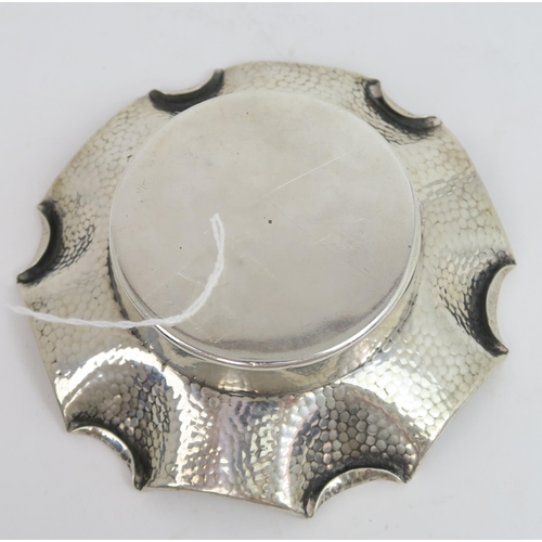 759B - A Victorian silver arts and crafts style dish, the body with a hammered finish, with a fold over pie... 