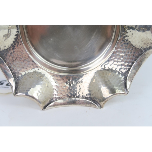 759B - A Victorian silver arts and crafts style dish, the body with a hammered finish, with a fold over pie... 