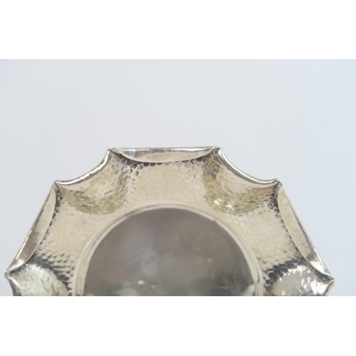 759B - A Victorian silver arts and crafts style dish, the body with a hammered finish, with a fold over pie... 