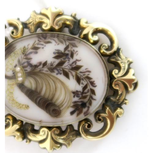 759C - A Victorian memorial hair art brooch. The scrolling yellow metal pendant brooch, has a locket to bot... 