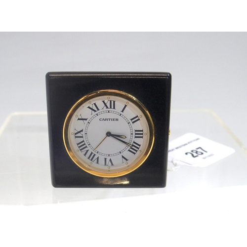 287 - A Cartier travel clock, model 0251 mounted in a black leather folding travel case, with number 01404... 